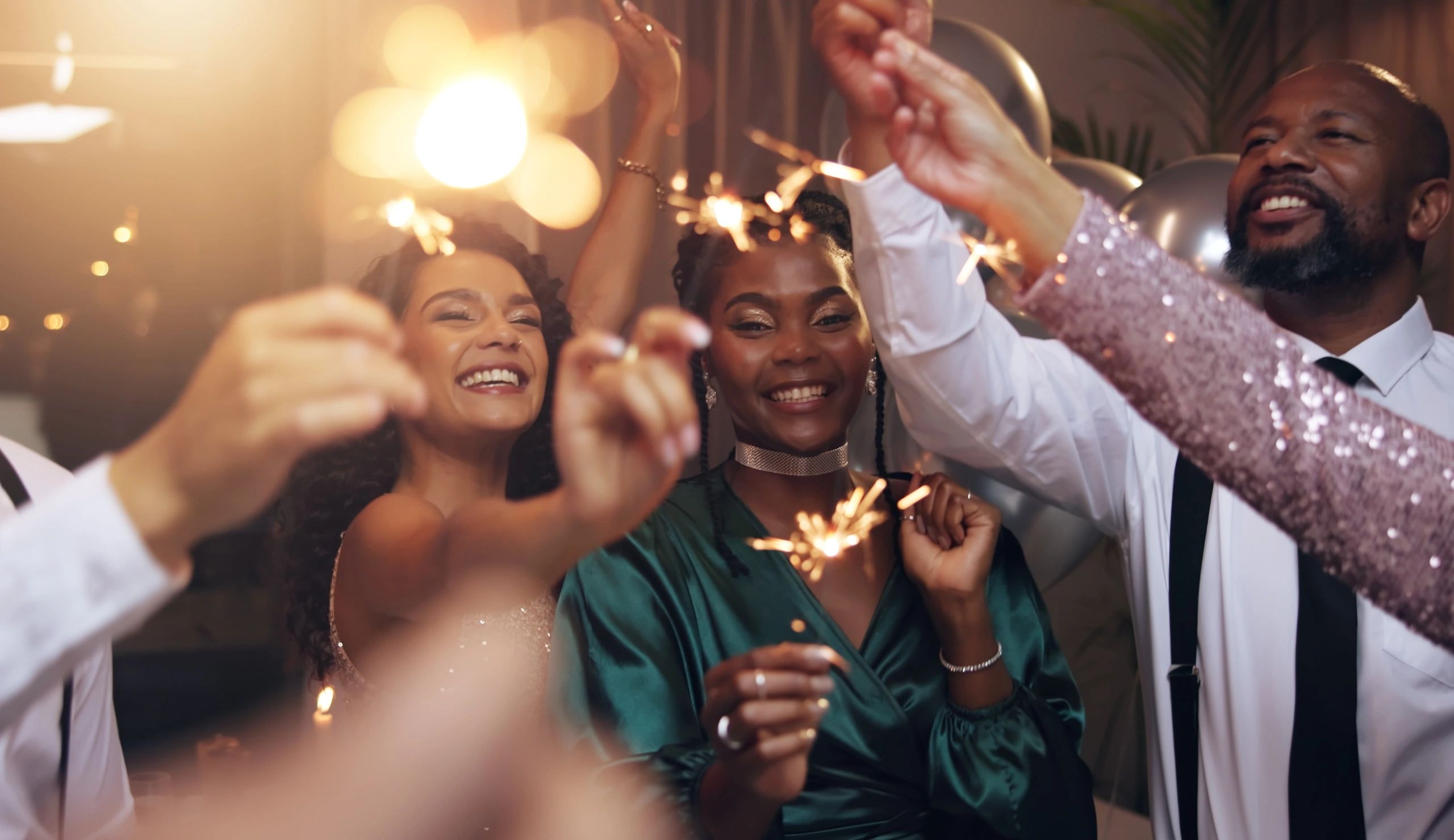 Group celebrating with sparklers and champagne at a formal event