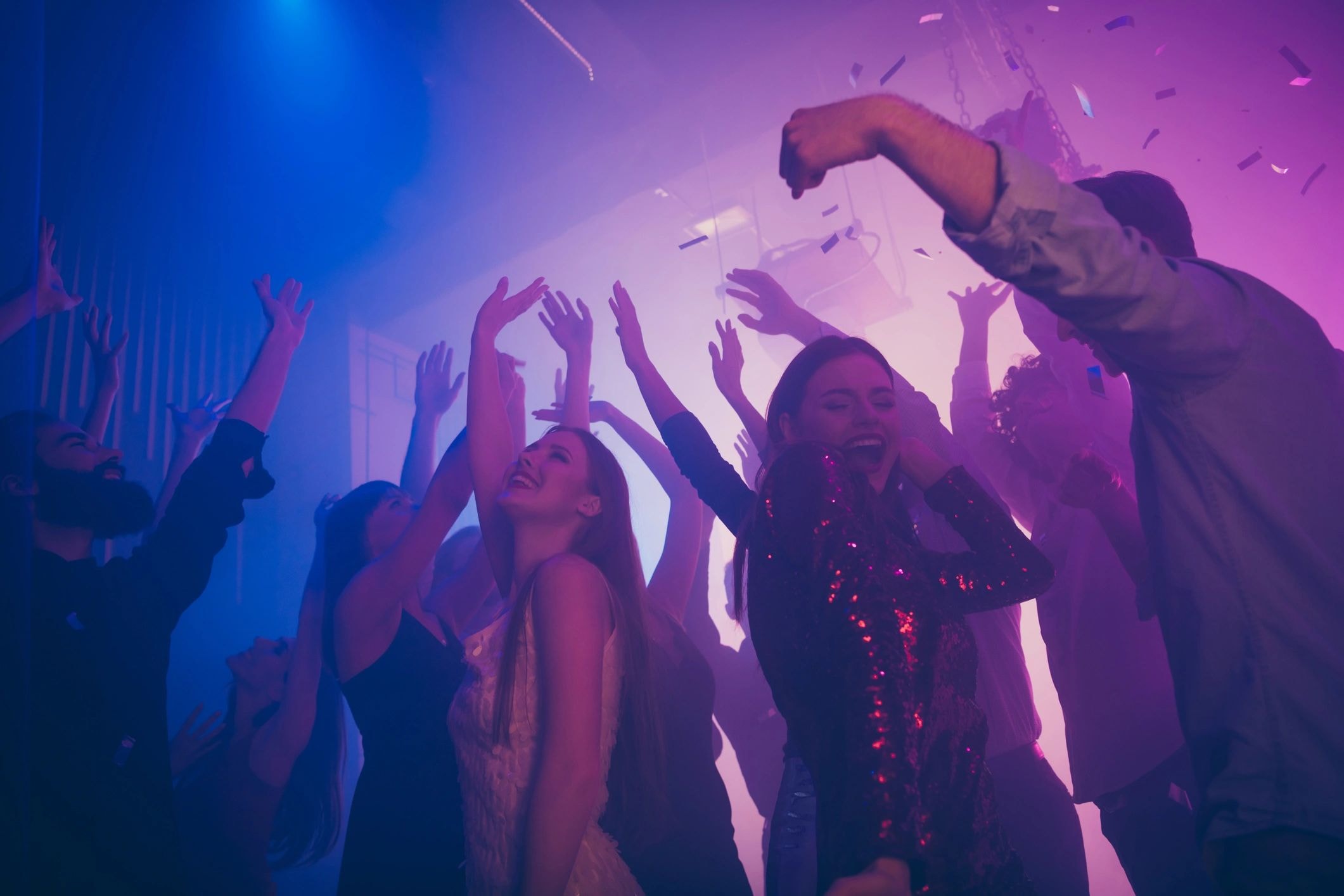 Nightclub dance floor with neon lights and confetti